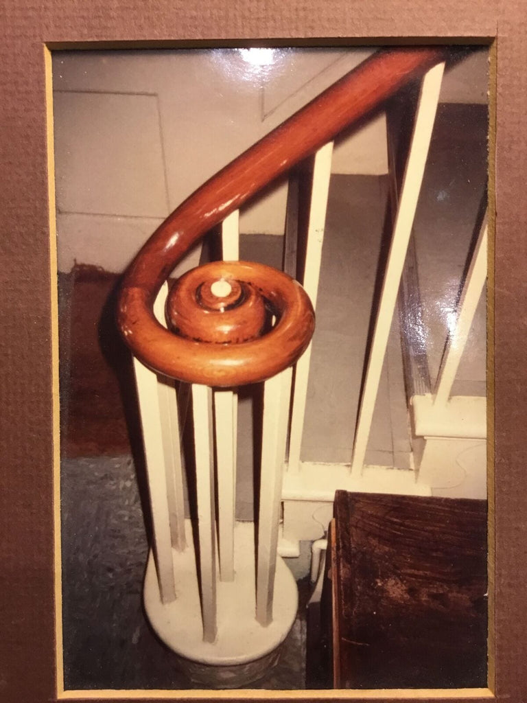 Wooden Staircase Banister With a Curved Spiral Design, Featured On a Custom Two Line Brag Button